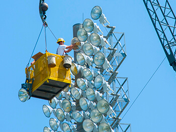 Worker changing light bulbs at a facility in Raleigh