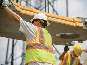 SIC team member holding up equipment during a turnkey industrial construction project