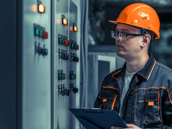 Worker checking out a panel as part of a complete plant maintenance program performed by Southern Industrial Contractors.