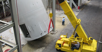 SIC team members moving large equipment during a plant relocation project